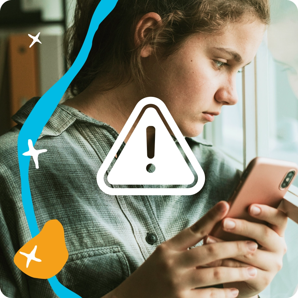 Photo of a girl looking out a window with a sad expression while holding her phone. An emergency icon is superimposed.