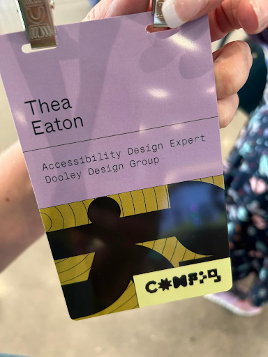 A close-up of Thea Eaton's conference badge, which reads: 'Thea Eaton, Accessibility Design Expert, Dooley Design Group,' with the Figma Config logo below.